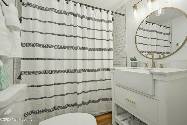 bathroom with hardwood / wood-style flooring, vanity, and toilet