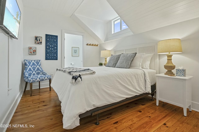 bedroom featuring lofted ceiling and wood-type flooring