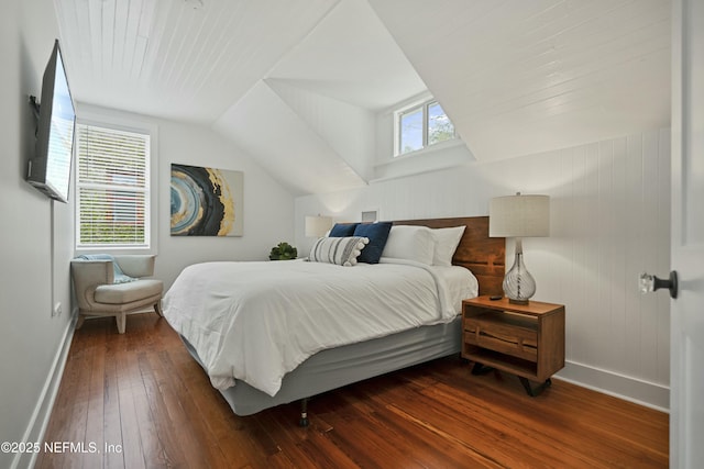 bedroom featuring multiple windows, lofted ceiling, and dark hardwood / wood-style floors