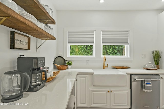 kitchen with white cabinetry, stainless steel dishwasher, and sink