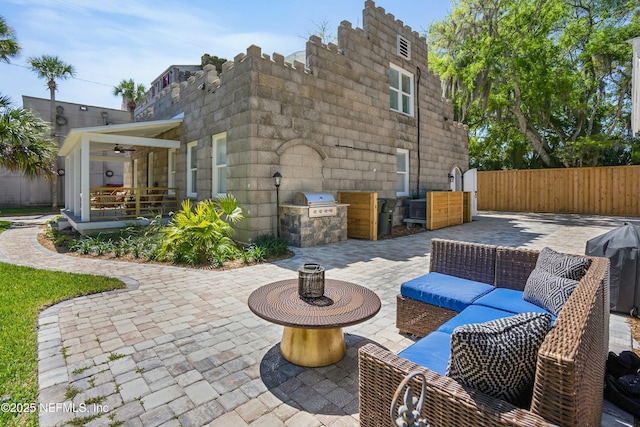 view of patio / terrace with ceiling fan, outdoor lounge area, exterior kitchen, and area for grilling