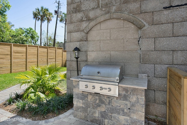 view of patio featuring area for grilling and a grill