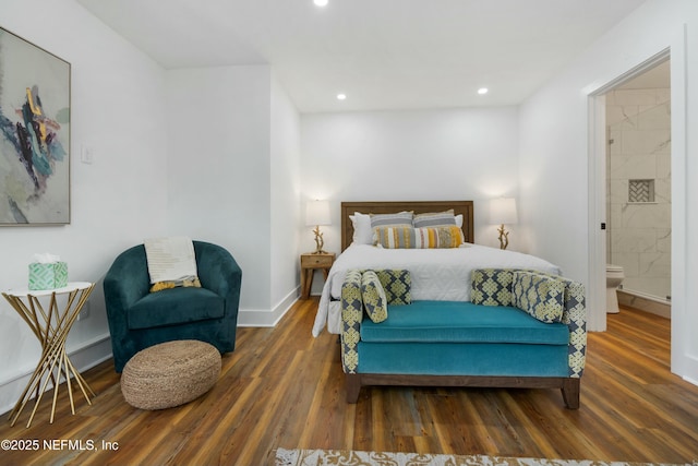 bedroom featuring connected bathroom and dark hardwood / wood-style floors