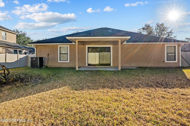 back of property featuring a patio, central AC, and a lawn