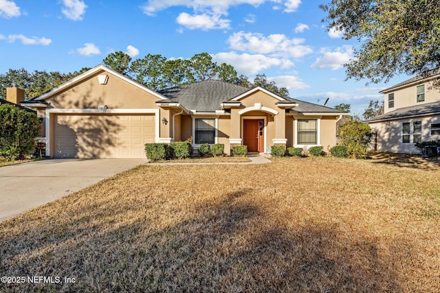 view of front of home featuring a garage and a front lawn