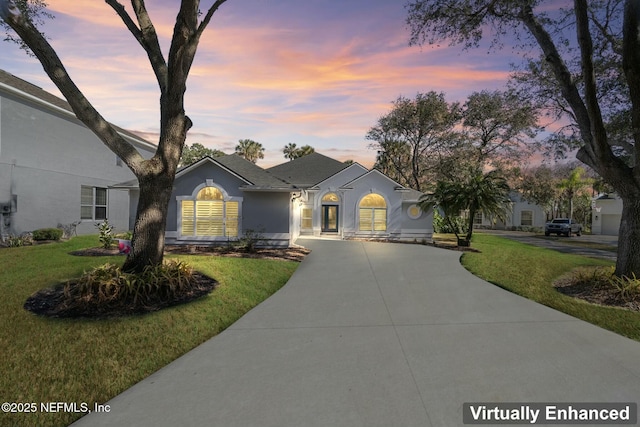 ranch-style house featuring a yard