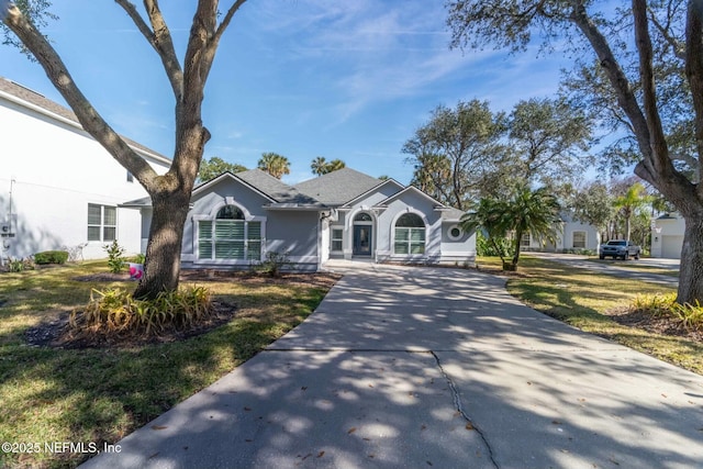 ranch-style home with a front lawn