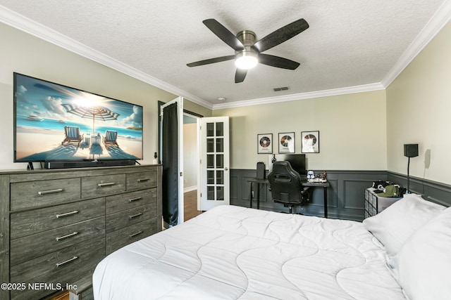 bedroom featuring crown molding, ceiling fan, and a textured ceiling