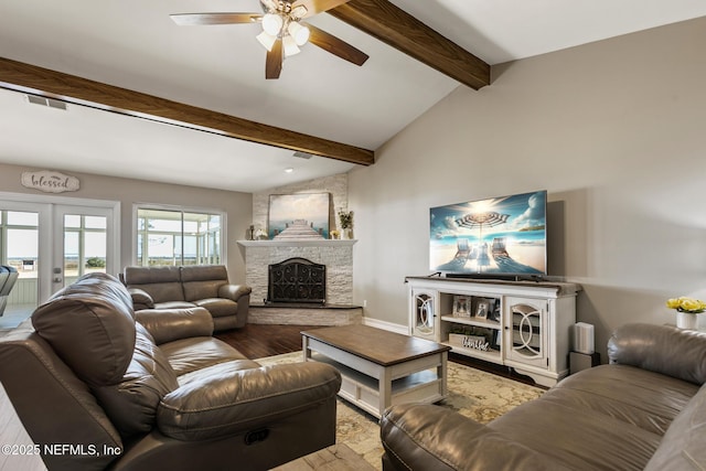 living room featuring hardwood / wood-style flooring, ceiling fan, vaulted ceiling with beams, a fireplace, and french doors