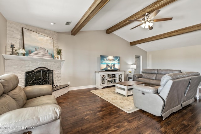 living room featuring dark hardwood / wood-style flooring, vaulted ceiling with beams, a stone fireplace, and ceiling fan