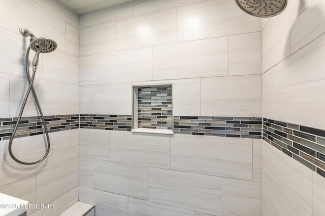 bathroom with a tile shower