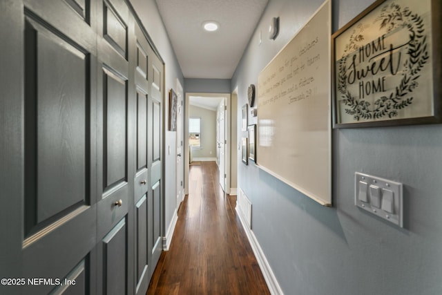 hallway featuring dark wood-type flooring