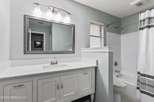 full bathroom featuring vanity, shower / bath combination with curtain, a textured ceiling, and toilet