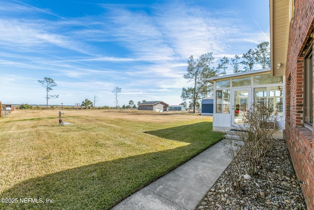 view of yard featuring a sunroom