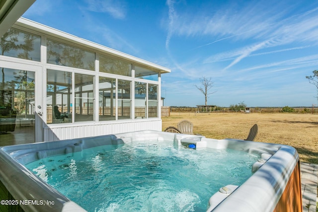 view of pool with a hot tub and a sunroom