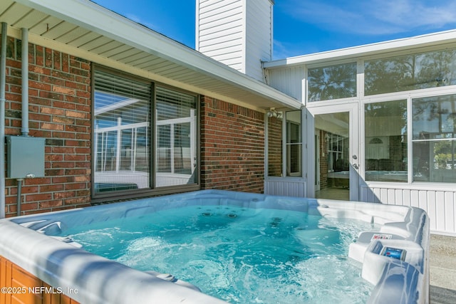 view of swimming pool with a hot tub