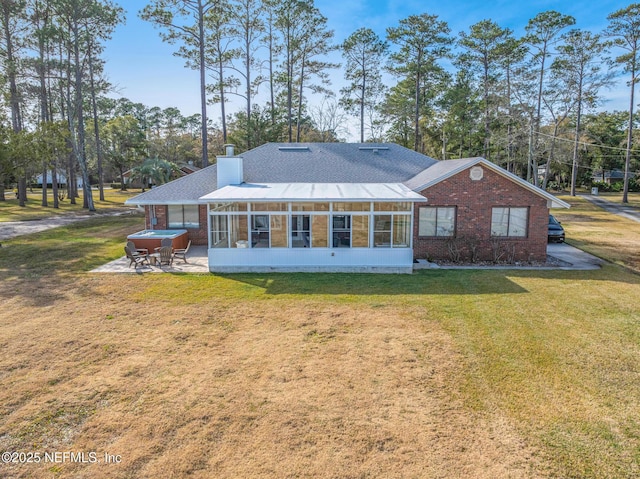 rear view of house with a patio, a sunroom, and a yard