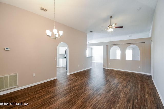 unfurnished living room featuring dark hardwood / wood-style flooring, ceiling fan with notable chandelier, and high vaulted ceiling