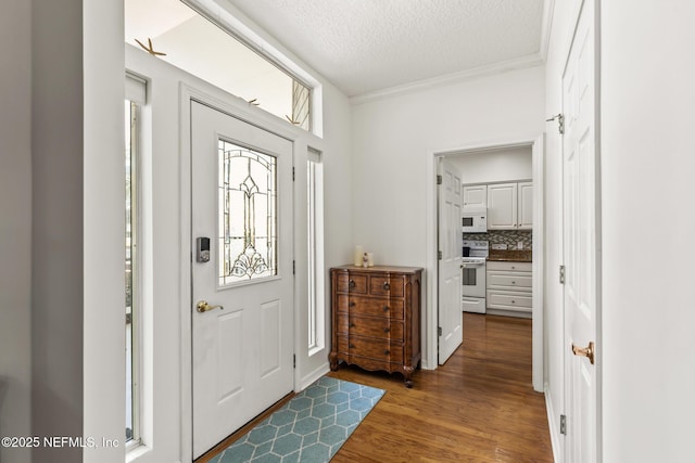 entryway featuring crown molding, dark hardwood / wood-style floors, and a textured ceiling