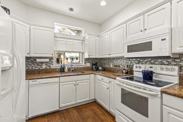 kitchen with sink, white cabinets, and white appliances