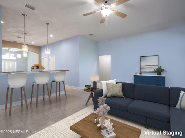 living room featuring ceiling fan and light tile patterned floors