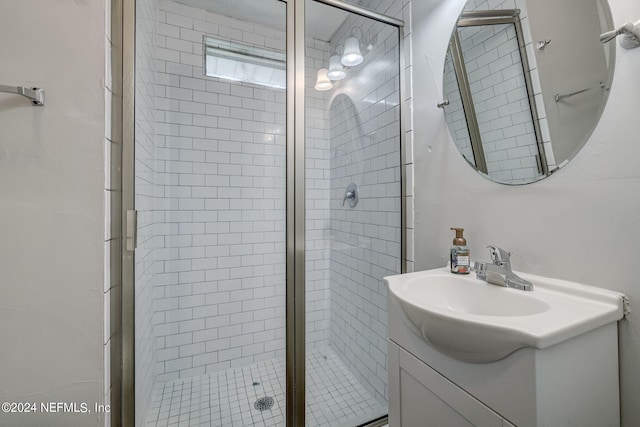 bathroom with vanity and a shower with door