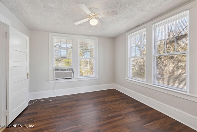 empty room with ceiling fan, cooling unit, a textured ceiling, and dark hardwood / wood-style flooring