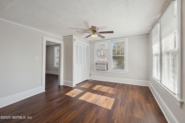 spare room with ceiling fan, crown molding, dark hardwood / wood-style floors, and a textured ceiling