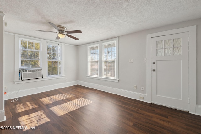 unfurnished room featuring ceiling fan, cooling unit, a textured ceiling, and dark hardwood / wood-style flooring