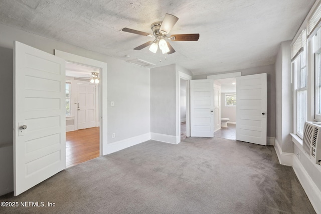 interior space with a healthy amount of sunlight, carpet flooring, and a textured ceiling