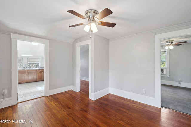 spare room with ornamental molding, a wealth of natural light, and light wood-type flooring