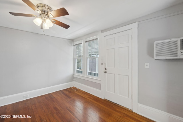 entrance foyer with wood-type flooring, a wall unit AC, and ceiling fan