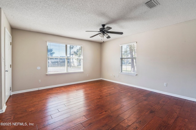 unfurnished room featuring ceiling fan, plenty of natural light, and dark hardwood / wood-style floors