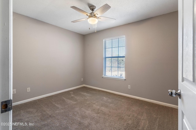 carpeted spare room featuring a textured ceiling and ceiling fan