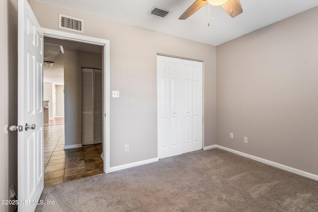 unfurnished bedroom featuring carpet floors, ceiling fan, and a closet