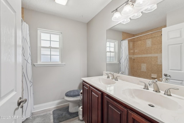 bathroom with hardwood / wood-style flooring, vanity, curtained shower, and toilet