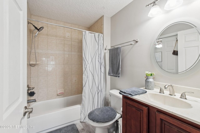 full bathroom featuring shower / tub combo with curtain, vanity, toilet, and a textured ceiling