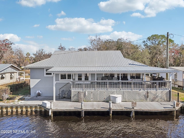 dock area featuring a deck with water view