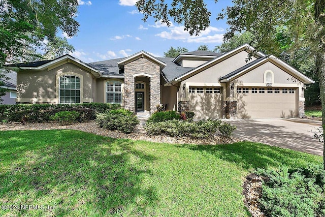 view of front of home featuring a garage and a front yard