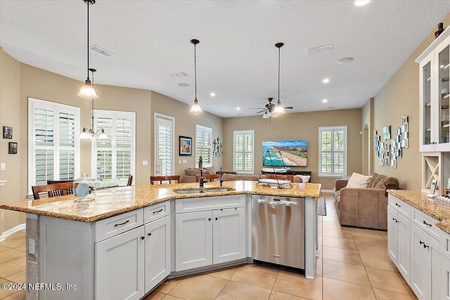 kitchen featuring pendant lighting, sink, dishwasher, a kitchen island with sink, and white cabinets