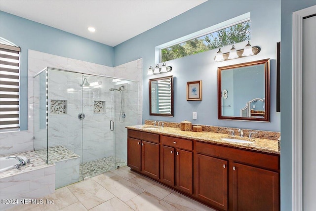 bathroom featuring vanity and separate shower and tub