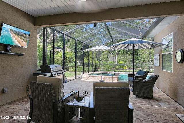 view of patio / terrace with a lanai, area for grilling, and a pool with hot tub