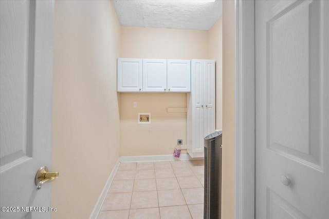 laundry room with light tile patterned flooring, cabinets, washer hookup, hookup for an electric dryer, and a textured ceiling