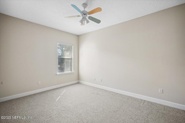 carpeted empty room with ceiling fan and a textured ceiling