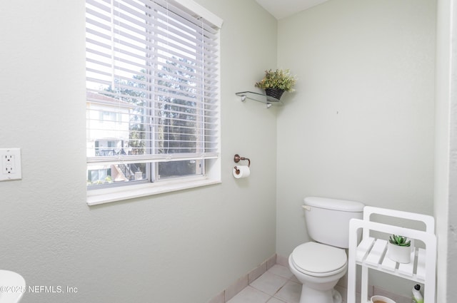 bathroom featuring tile patterned flooring and toilet