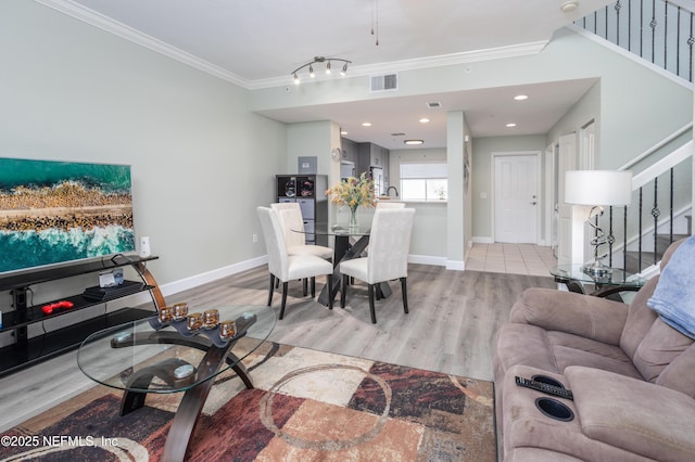 living room with ornamental molding and light wood-type flooring