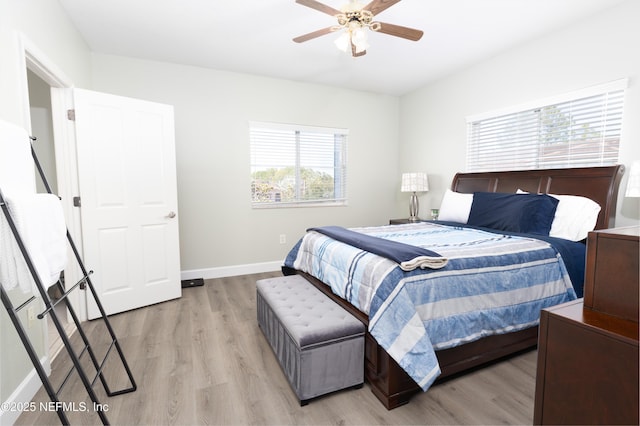 bedroom with light hardwood / wood-style floors and ceiling fan