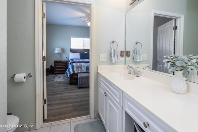 bathroom featuring vanity, tile patterned floors, ceiling fan, and toilet