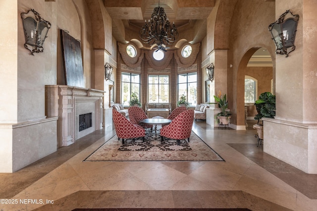 dining space with beam ceiling, coffered ceiling, a towering ceiling, and an inviting chandelier