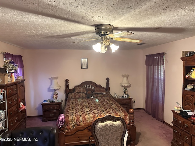 carpeted bedroom with ceiling fan and a textured ceiling